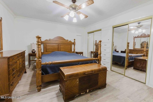 bedroom with crown molding, multiple closets, ceiling fan, and light wood-type flooring