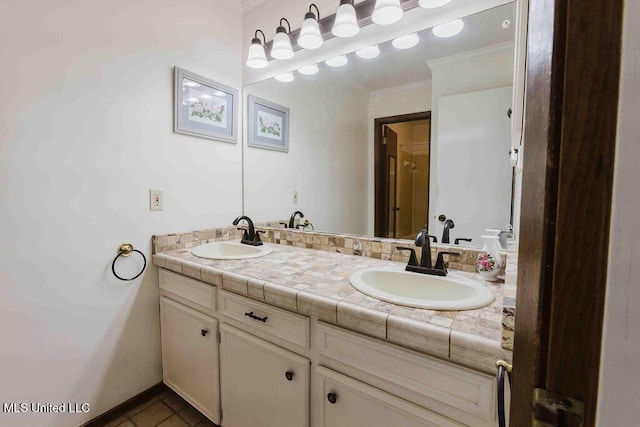 bathroom featuring a sink, crown molding, and double vanity