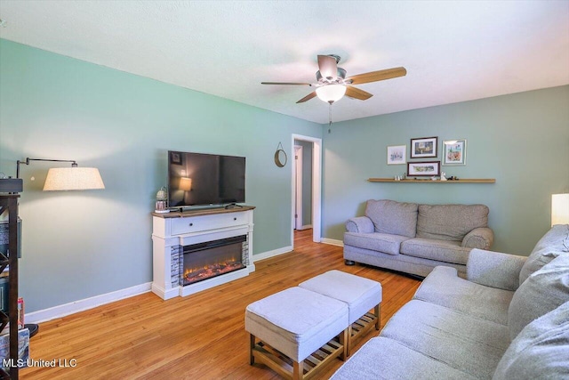 2709 Burma Dr, Pearl, MS 39208 - living area featuring ceiling fan, wood finished floors, and a glass covered fireplace
