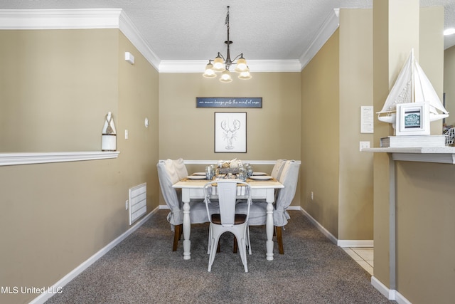 dining area featuring crown molding, light tile patterned floors, a textured ceiling, and a chandelier