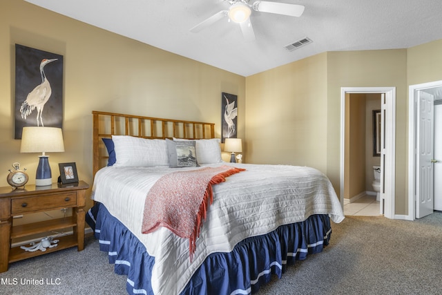 bedroom featuring ensuite bathroom, ceiling fan, and carpet floors