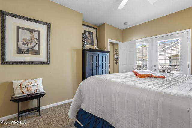 carpeted bedroom featuring access to outside, ceiling fan, and a textured ceiling