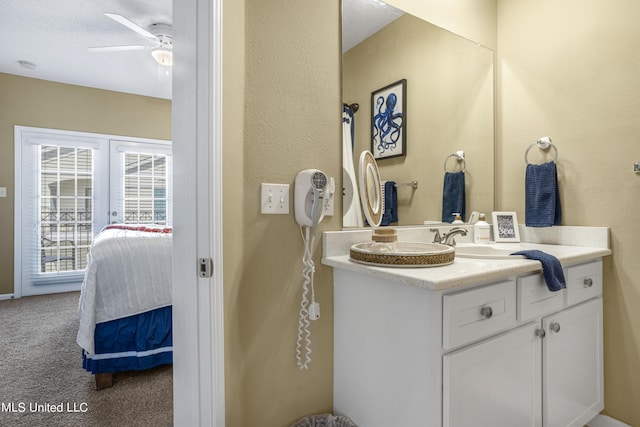 bathroom featuring ceiling fan and vanity