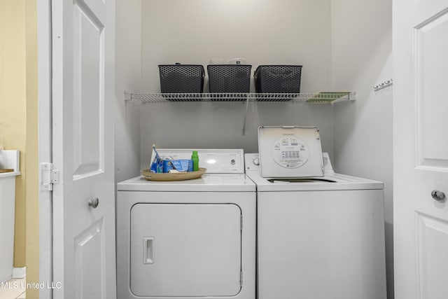 clothes washing area featuring washer and clothes dryer