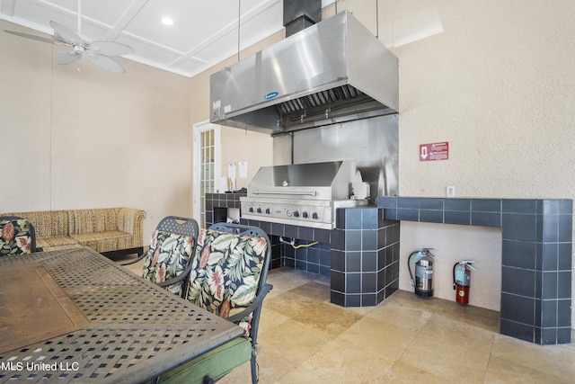 kitchen featuring ceiling fan and ventilation hood