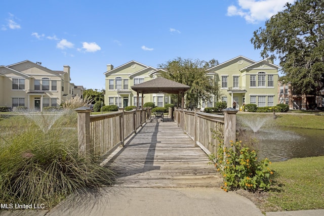 view of property's community with a gazebo and a water view