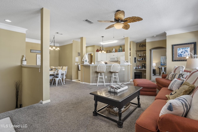 carpeted living room featuring crown molding, ceiling fan with notable chandelier, and a textured ceiling