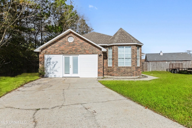 ranch-style house with brick siding, french doors, a shingled roof, and a front yard