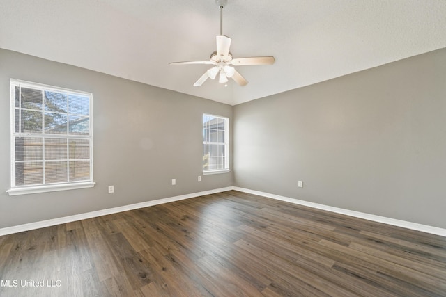 unfurnished room featuring baseboards, wood finished floors, and a ceiling fan