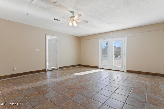 spare room featuring baseboards, visible vents, a textured ceiling, and ceiling fan