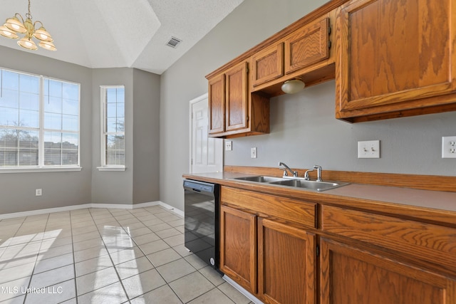 kitchen with visible vents, baseboards, dishwasher, light tile patterned floors, and brown cabinets