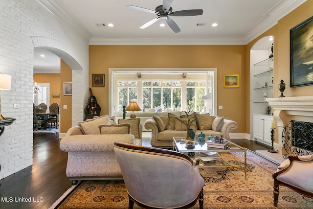 living room featuring ceiling fan, ornamental molding, and dark hardwood / wood-style floors