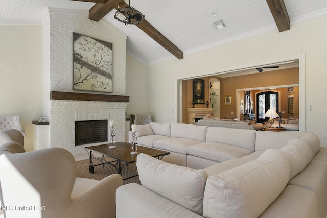 living room featuring lofted ceiling with beams and a fireplace