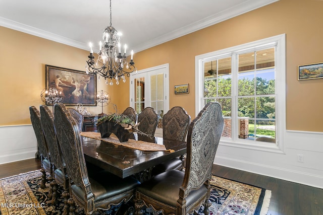 dining room with an inviting chandelier, french doors, dark wood-type flooring, and crown molding