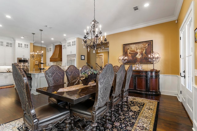 dining room featuring crown molding and dark hardwood / wood-style floors