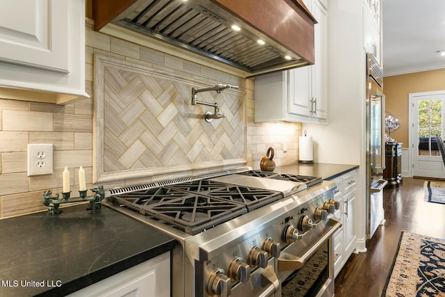 kitchen featuring white cabinets, tasteful backsplash, dark wood-type flooring, and high end stainless steel range