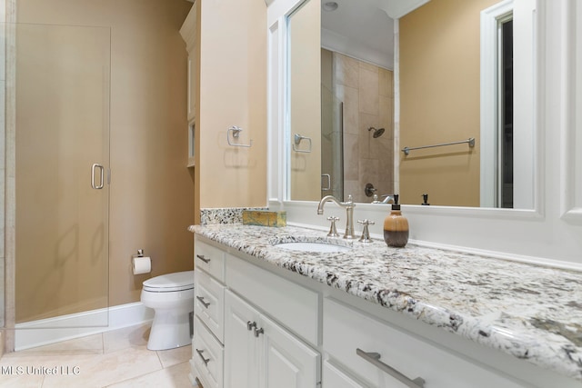 bathroom with vanity, toilet, tile patterned floors, and a shower with door