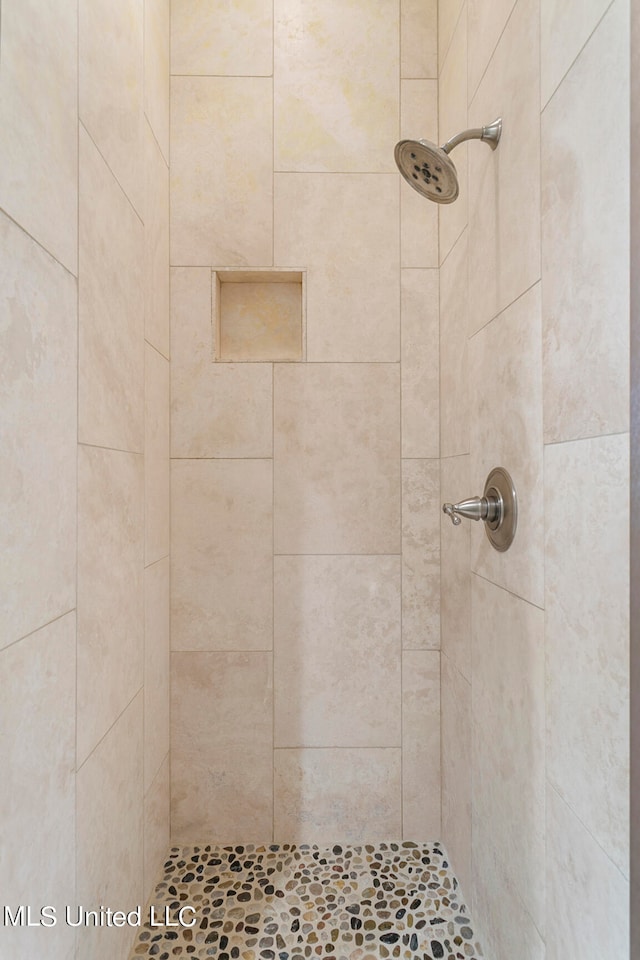 bathroom with a tile shower