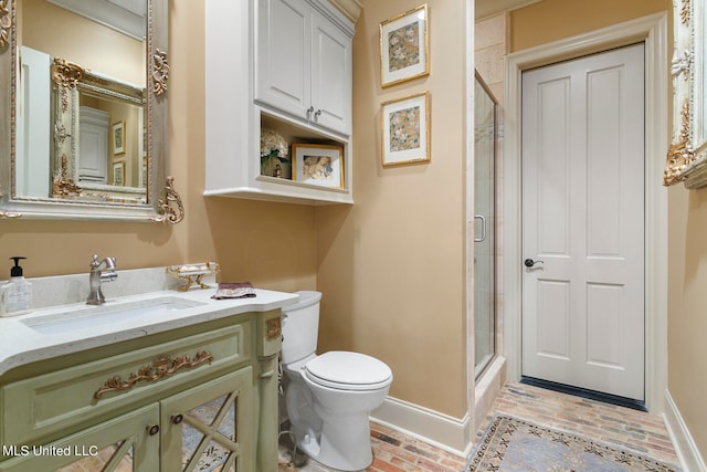 bathroom with vanity, walk in shower, and toilet