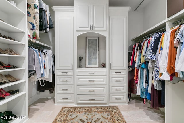 spacious closet featuring light tile patterned floors