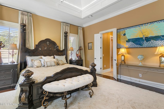 bedroom with ornamental molding and hardwood / wood-style floors