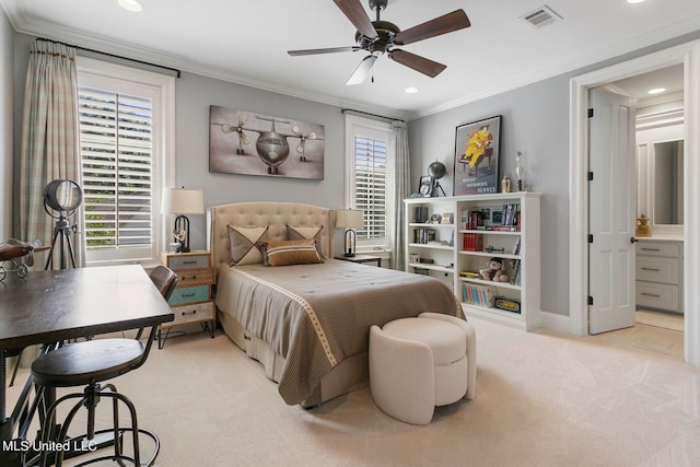 bedroom featuring crown molding, ensuite bath, light colored carpet, and ceiling fan