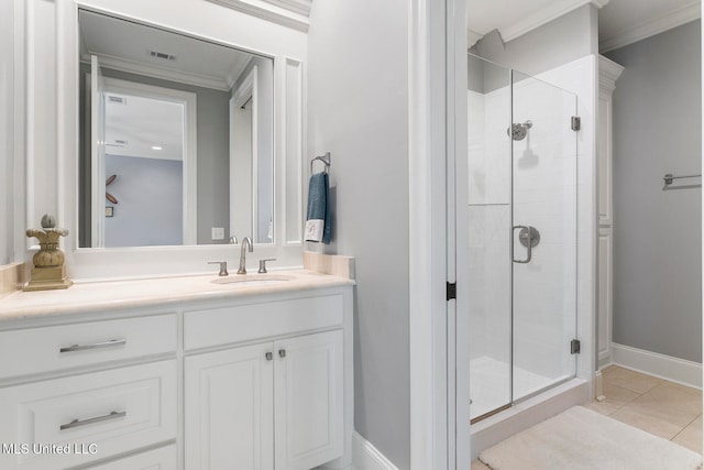 bathroom featuring vanity, ornamental molding, a shower with shower door, and tile patterned flooring