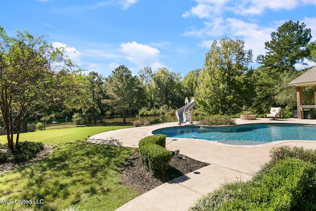 view of pool with a water slide, a yard, and a patio