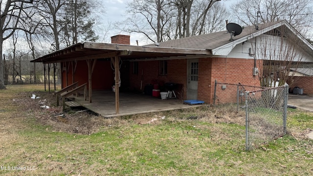 back of property featuring a lawn