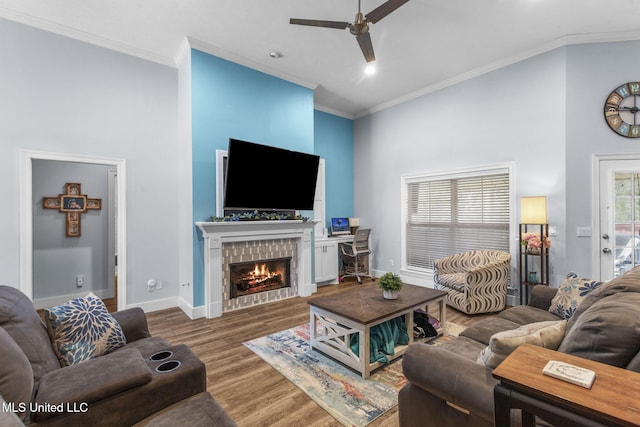 527 Pelahatchie Shore Dr, Brandon, MS 39047 - living room with a ceiling fan, wood finished floors, a tiled fireplace, a high ceiling, and crown molding