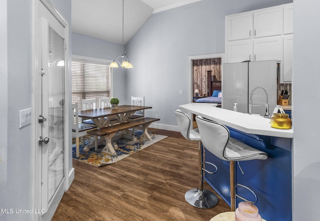 527 Pelahatchie Shore Dr, Brandon, MS 39047 - dining room featuring vaulted ceiling, dark wood-style floors, baseboards, and a chandelier