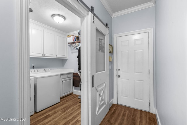 527 Pelahatchie Shore Dr, Brandon, MS 39047 - laundry room featuring washer / dryer, cabinet space, dark wood-style flooring, crown molding, and a barn door