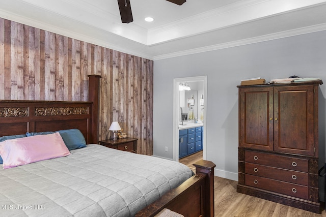 527 Pelahatchie Shore Dr, Brandon, MS 39047 - bedroom featuring light wood-style floors, ensuite bathroom, ornamental molding, a ceiling fan, and a raised ceiling