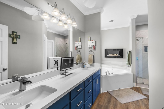 527 Pelahatchie Shore Dr, Brandon, MS 39047 - bathroom featuring a bath, a shower stall, double vanity, wood finished floors, and ornamental molding