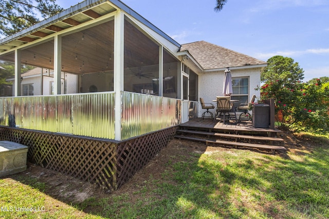 527 Pelahatchie Shore Dr, Brandon, MS 39047 - rear view of house with a sunroom, roof with shingles, a wooden deck, brick siding, and a ceiling fan