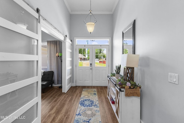 527 Pelahatchie Shore Dr, Brandon, MS 39047 - entrance foyer with a barn door, wood finished floors, crown molding, and baseboards