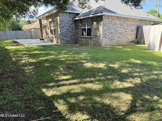 back of house with brick siding, a patio, and a fenced backyard