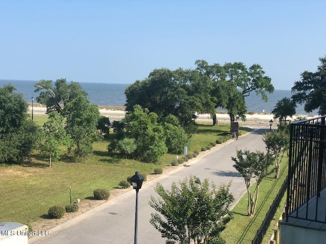 view of community with a yard and a water view