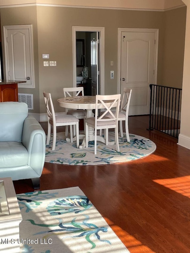 dining room with dark hardwood / wood-style flooring