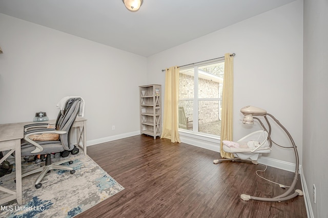 office space featuring baseboards and wood finished floors