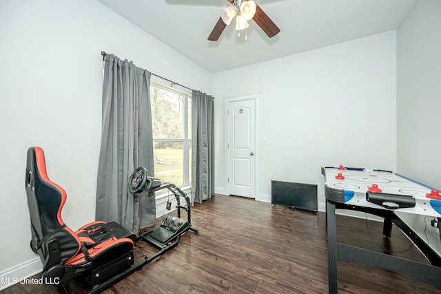 recreation room with baseboards, ceiling fan, and wood finished floors