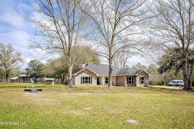 view of front facade with a front lawn and brick siding