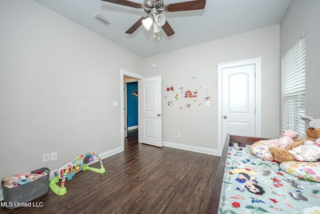 unfurnished bedroom with ceiling fan, visible vents, baseboards, and dark wood finished floors