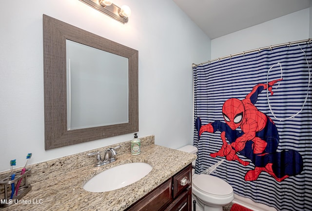 bathroom featuring vanity, a shower with shower curtain, and toilet