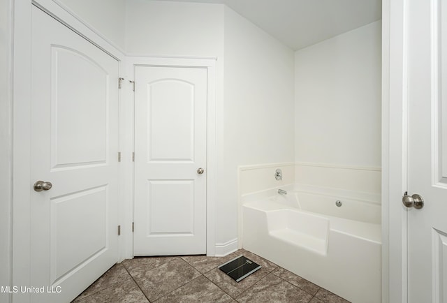 full bathroom featuring a garden tub and tile patterned flooring