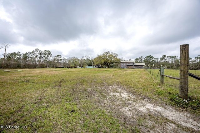 view of yard featuring a rural view and fence