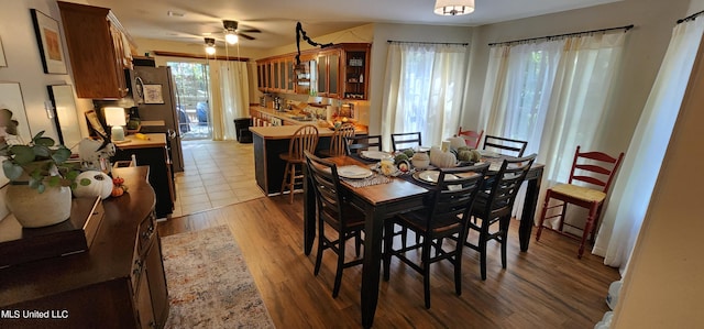 dining area featuring wood-type flooring and ceiling fan