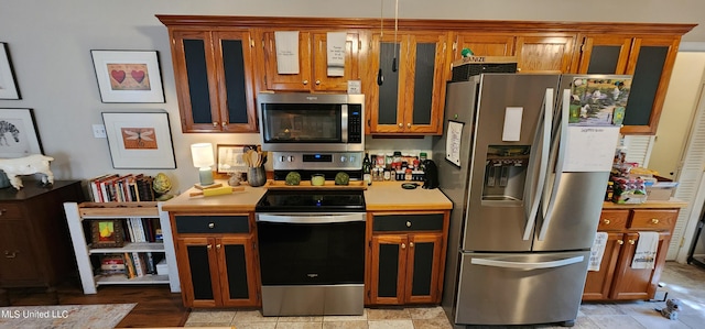 kitchen featuring light tile patterned floors and appliances with stainless steel finishes