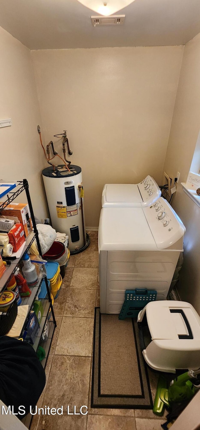 clothes washing area featuring independent washer and dryer and electric water heater