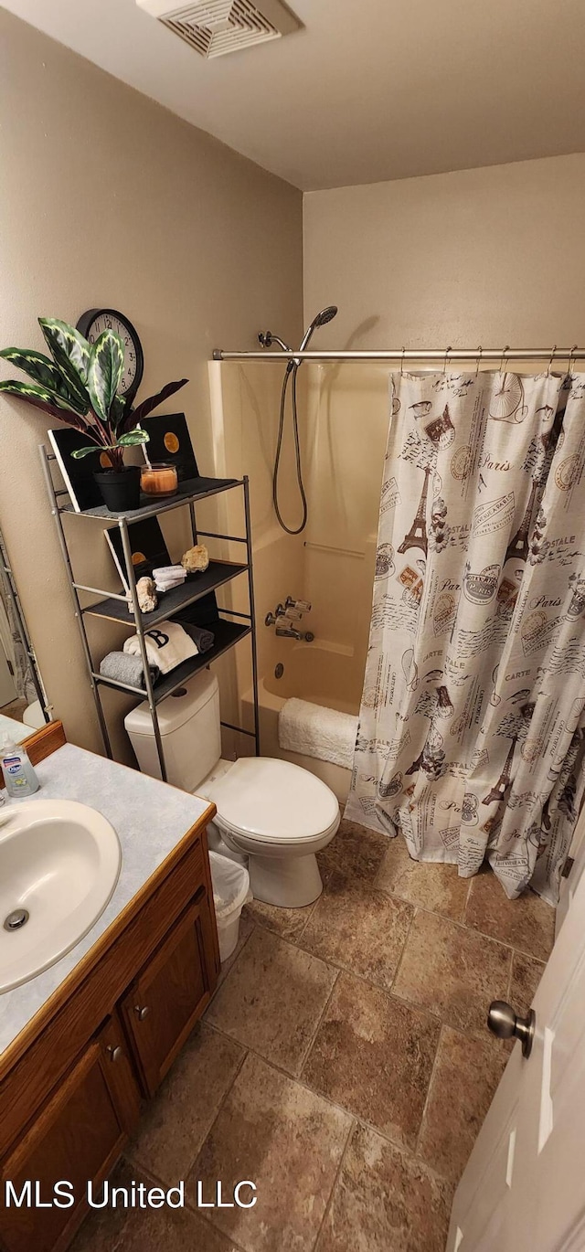 full bathroom featuring shower / bath combo, toilet, and vanity